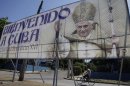 A man rides his bicycle past a billboard welcoming Pope Benedict XVI, just days before his arrival, in Havana, Cuba, Wednesday March 21, 2012. Pope Benedict XVI's trip to Latin America takes him to the region's most Catholic country; Mexico, and then Cuba, where churches are mostly empty and until the 1990s, believers were barred from the Communist Party. (AP Photo/Javier Galeano)