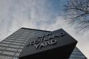The New Scotland Yard sign stands outside the headquarters of the Metropolitan Police, in central London on January 11, 2013