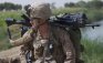 A U.S. Marine of 3rd Platoon, Kilo Company, 3/4 Marines, carries his second rifle, a machine gun, atop his backpack, as he arrives on foot at a small outpost, Patrol Base 302, in Helmand province, southern Afghanistan, Thursday Aug. 25, 2011. The Marines living in austere conditions at PB-302 exchange fire regularly with Taliban who attack from multiple directions. (AP Photo/Brennan Linsley)