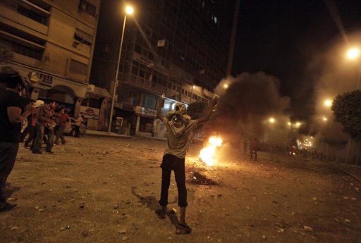 A Protester holds firebombs during clashes with armed men at the Abbasiyah area in Cairo, Egypt, Saturday, July 23, 2011. Groups of men armed with knives and sticks attacked thousands of protesters trying to march to the headquarters of Egypt's military rulers Saturday, setting off fierce street clashes and leaving dozens injured, most lightly. Security fired tear gas to disperse the crowd. (AP Photo/Khalil Hamra)