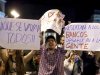 Demonstrators against Spain's bailout hold up signs in Madrid