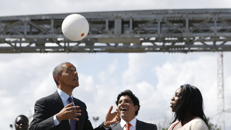 U.S. President Barack Obama bounces a soccer ball with his head at Ubungo Power Plant in Dar es Salaam