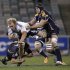 Burger of South Africa's Stormers is tackled by Salvi and Chisholm of Australia's Brumbies during their Super 15 rugby union match in Canberra