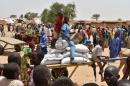 Displaced people fleeing from Boko Haram incursions into Niger wait for a food distribution at the Asanga refugee camp near Diffa on June 16, 2016 following attacks by Nigeria-based Boko Haram fighters in the region