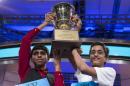 Ansun Sujoe, 13, left, of Fort Worth, Texas, and Sriram Hathwar, 14, of Painted Post, N.Y., raise the championship trophy after being named co-champions of the Scripps National Spelling Bee, on Thursday, May 29, 2014, in Oxon Hill, Md. (AP Photo/ Evan Vucci)