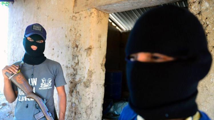 Two former &quot;punteros&quot; (informants) of the Knights Templar drug cartel, pose during an interview with AFP at la Nopalera community, Michoacan state, Mexico, on February 15, 2014