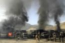 Nato troops and Afghan security forces arrive at the site of burning NATO supply trucks after an attack by militants in the Torkham area near the Pakistani-Afghan in Nangarhar Province