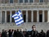 A woman raises a Greek flag during an anti-austerity rally in front of the parliament in Athens