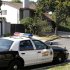An unoccupied Los Angeles County Sheriff's Department patrol car is parked across from the home, background, of Nakoula Basseley Nakoula, the man who made the film "Innocence of Muslims" that has sparked violent protests, in Cerritos, Calif., Tuesday, Sept. 25, 2012. The filmmaker has received death threats and was forced into hiding, putting his home up for sale, after the 14-minute movie trailer rose to prominence. (AP Photo/Reed Saxon)
