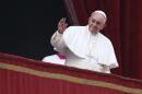 Pope Francis waves as he delivers a "Urbi et Orbi" (to the city and world) message from the balcony overlooking St. Peter's Square at the Vatican