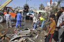Street cleaners remove debris on the road after a car bomb exploded in Diwaniya province, 150 km (95 miles) south of Baghdad