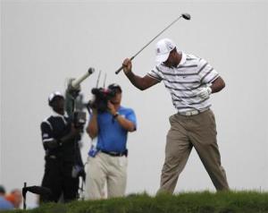 Tiger Woods reacts after his tee shot on the sixth hole during the PGA Golf Championship at Whistling Straits