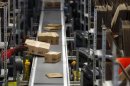 A worker packs boxes at Amazon's logistics centre in Graben near Augsburg