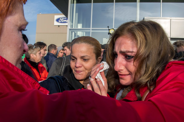 Ford workers react after the European Ford management announced it would close the Ford plant in Genk, Belgium on Wednesday Oct. 24, 2012. A union leader says Ford has decided to close its factory in Genk, Belgium, at the end of 2014 in a move that will result in 4,500 direct job losses and 5,000 more among subcontractors. (AP Photo/Geert Vanden Wijngaert)