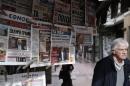 Greek Prime Minister Alexis Tsipras is pictured on newspapers at a kiosk in Athens