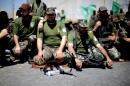 Palestinian militants attend Friday noon prayers at a street in Beit Lahia in the northern Gaza Strip on September 6, 2013