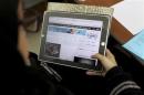 A Saudi woman explores a website on her tablet in Riyadh