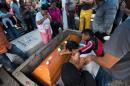 Relatives and friends of Mexican journalist Pedro Tamayo Rosas cry over his coffin during his funeral in Tierra Blanca on July 22, 2016