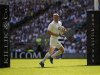 England's Ashton runs to score a try against Barbarians during their rugby union match in London