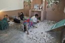 Hindus clean a temple after being attacked by a group of Muslim men in Karachi, Pakistan, Sunday, Sept. 30, 2012. A group of Muslims suspected of ransacking a Hindu temple in southern Pakistan may be charged with blasphemy, police said Sunday. The case is a rare twist on the use of the country's harsh blasphemy laws, which are more often invoked against supposed offenses to Islam as opposed to minority faiths. (AP Photo/Fareed Khan)