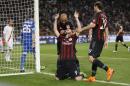 AC Milan's Mattia Destro celebrates with his teammates Alex Dias da Costa and Gabriel Paletta, right, after scoring during a Serie A soccer match between AC Milan and Roma, at the San Siro stadium in Milan, Italy, Saturday, May 9, 2015. (AP Photo/Luca Bruno)