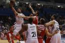 Olympiakos' Vangelis Mantzaris, right, jumps to stop Real Madrid's Sergio Llull during a Euroleague playoff game 3 basketball match at the Peace and Friendship Arena in Athens' port of Piraeus on Monday, April 21, 2014. (AP Photo/Thanassis Stavrakis)