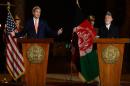Afghanistan's president Hamid Karzai (R) and US Secretary of State John Kerry give a joint press conference at the presidential palace in Kabul on October 12, 2013