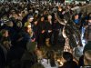 People gather at a statue of former Penn State football coach Joe Paterno in State College, Pa, on Saturday, Jan. 21,  2012. Joe Paterno's  doctors say the former coach's condition has become "serious" after he experienced complications from lung cancer in recent days. (AP Photo/John Beale)