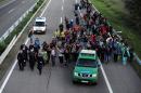 Migrants walk along the M5 highway in Hungary heading for Budapest, after breaking out from a collection point near Roszke on September 7, 2015
