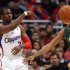 Los Angeles Clippers' guard Chris Paul, left, makes a pass as he is defended by Utah Jazz's guard Devin Harris during the first half of a NBA basketball game in Los Angeles, Saturday, March 31, 2012.  (AP Photo/Ringo H.W. Chiu)