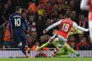 Manchester United's Wayne Rooney, left, scores a goal during the English Premier League soccer match between Arsenal and Manchester United at the Emirates Stadium, London, Saturday, Nov. 22, 2014. (AP Photo/Tim Ireland)