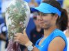 Li Na, from China, gives a thumbs-up while holding the championship trophy after defeating Angelique Kerber, from Germany, 1-6, 6-3, 6-1 during the women's final at the Western & Southern Open tennis tournament on Sunday, Aug. 19, 2012, in Mason, Ohio. (AP Photo/Al Behrman)