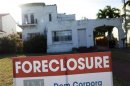 A foreclosure sale sign sits in front of a house in Miami Beach