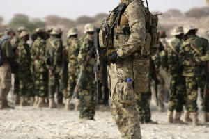 A U.S. special forces soldier stands in front of Chadian soldiers during Flintlock 2015, an American-led military exercise, in Mao