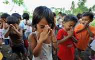 Young Filipino children pray during a religious service near the town of Guinobatan in 2009. The Philippines leads the world in the number of people who believe in God, while the elderly across all countries tend to be the most religious, according to a US study out Wednesday