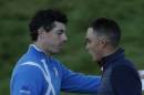 Europe's Rory McIlroy, left, and Rickie Fowler, right, of the US shake hands at the end of their foursomes match on the first day of the Ryder Cup golf tournament at Gleneagles, Scotland, Friday, Sept. 26, 2014. (AP Photo/Matt Dunham)