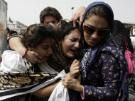 Family members of Pakistani acid attack victim Fakhra Younnus, mourn her death at Karachi airport in Pakistan on Sunday, March 25, 2012. Fakhra, who committed suicide by jumping from the sixth floor of her flat in Rome, was a victim of an acid attack allegedly carried out 12 years ago by her husband, the son of a feudal politician. (AP Photo)