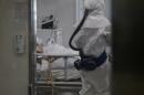 A medical staff member wearing a protective suit enters the room of a patient suffering from Middle East Respiratory Syndrome (MERS) in an isolation ward at the Seoul Medical Center in Seoul on June 10, 2015