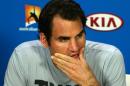 Roger Federer of Switzerland reacts during a press conference after his third round loss to Andreas Seppi of Italy at the Australian Open tennis championship in Melbourne, Australia, Friday, Jan. 23, 2015. (AP Photo/Rob Griffith)