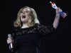 Adele celebrates with the award for the best British Album of the Year during the Brit Awards 2012 at the O2 Arena in London, Tuesday, Feb. 21, 2012. (AP Photo/Joel Ryan)