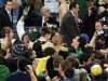 Notre Dame players including Zach Auguste, center right, and Jack Cooley, center left, celebrate with fans after their 104-101 win over Louisville in the fifth overtime of their NCAA college basketball game, Saturday, Feb. 9, 2013, in South Bend, Ind. (AP Photo/Joe Raymond)