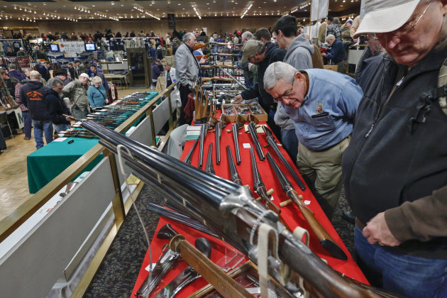 FILE - In this Saturday, Jan. 26, 2013 file photo, gun enthusiasts gather during the annual New York State Arms Collectors Association Albany Gun Show at the Empire State Plaza Convention Center, in Albany, N.Y. Key measures of New York's tough new gun law are set to kick in, with owners of guns now reclassified as assault weapons required to register the firearms and new limits on the number of bullets allowed in magazines. As the new provision takes effect Monday, April 15, 2013, New York's affiliate of the National Rifle Association said it plans to head to court to seek an immediate halt to the magazine limit. (AP Photo/Philip Kamrass, File)