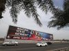 Vehicles travel past a large Bahrain Formula One advertising billboard on main highway leading to Bahrain Internaitonal Circuit, in Manama