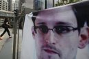 A banner supporting Edward Snowden, a former CIA employee who leaked top-secret documents about sweeping U.S. surveillance programs, is displayed at Central, Hong Kong's business district, Thursday, June 20, 2013. A WikiLeaks spokesman who claims to represent Snowden has reached out to government officials in Iceland about the potential of the NSA leaker applying for asylum in the Nordic country, officials there said Wednesday. (AP Photo/Kin Cheung)