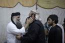 In this Wednesday, Sept. 24, 2014 photo, radical al-Qaida-linked preacher Abu Qatada, first left, receives a friend, on the day he was released from Jordanian prison after an acquittal on security charges, in Amman, Jordan. Abu Qatada and Abu Mohammed al-Maqdisi, two of Jordan's top pro-al-Qaida ideologues held court on the rooftop of a villa whispering to each other and rising occasionally from plastic chairs to greet supporters. The two have denounced some of the Islamic State group's practices as un-Islamic - comments some analysts say have turned the preachers into assets in Jordan's campaign to contain the Islamic State, which is believed to have attracted thousands of followers in Jordan. (AP photo/Mohammad Hannon)