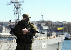 A member of the Russian troops stands guard near a …