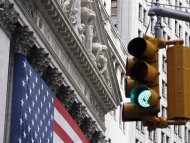 Traffic signal flashes green outside the New York Stock Exchange in New York