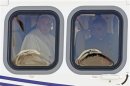 Pope Francis looks through the window of his helicopter before boarding a plane at Fiumicino airport in Rome