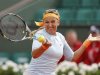 Azarenka of Belarus hits a return to Vesnina of Russia during their women's singles match at the French Open tennis tournament in Paris