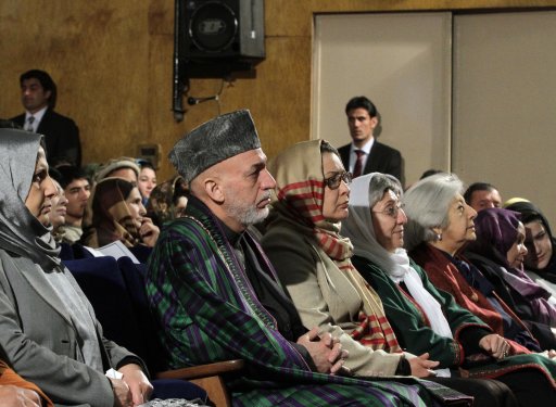 Afghan President Hamid Karzai sits among the audience prior to his nationally televised speech about the state of Afghan women in Kabul, Afghanistan, Sunday, March, 10, 2013. Karzai on Sunday accused the Taliban and the U.S. of working in concert to convince Afghans that violence will worsen if most foreign troops leave as planned by the end of next year. Karzai says two deadly suicide bombings on Saturday show the insurgent group is conducting attacks to help show that international forces will still be needed to keep the peace after their current combat mission ends in 2014. (AP Photo/Ahmad Jamshid)